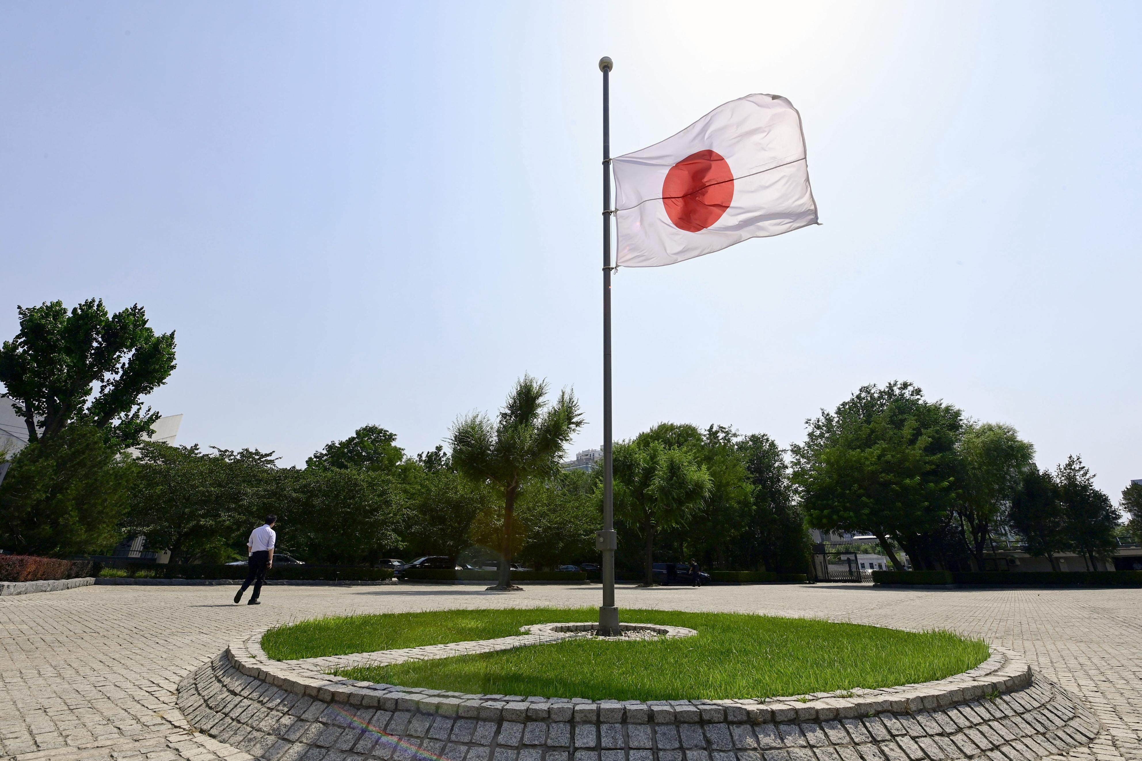 Japan’s national flag flies at half-mast at the country’s embassy in Beijing on Friday in honour of Hu Youping. The Chinese woman was fatally injured in trying to save Japanese schoolchildren from a knife attack. Photo: Kyodo