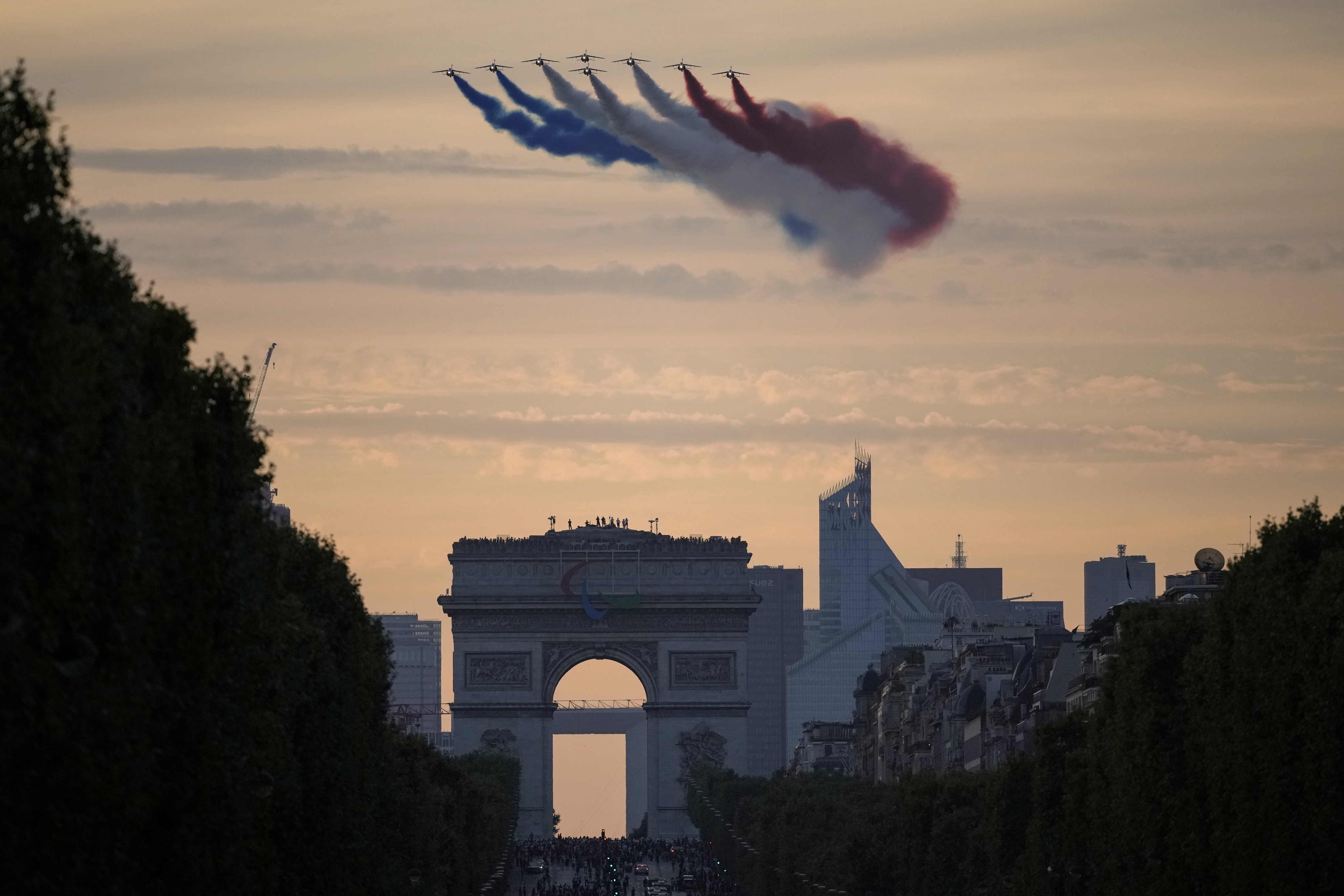 Alpha Jets from the Patrouille de France fly over the Champs-Elysees as delegations arrive for the opening ceremony for the 2024 Paralympics. Photo: AP