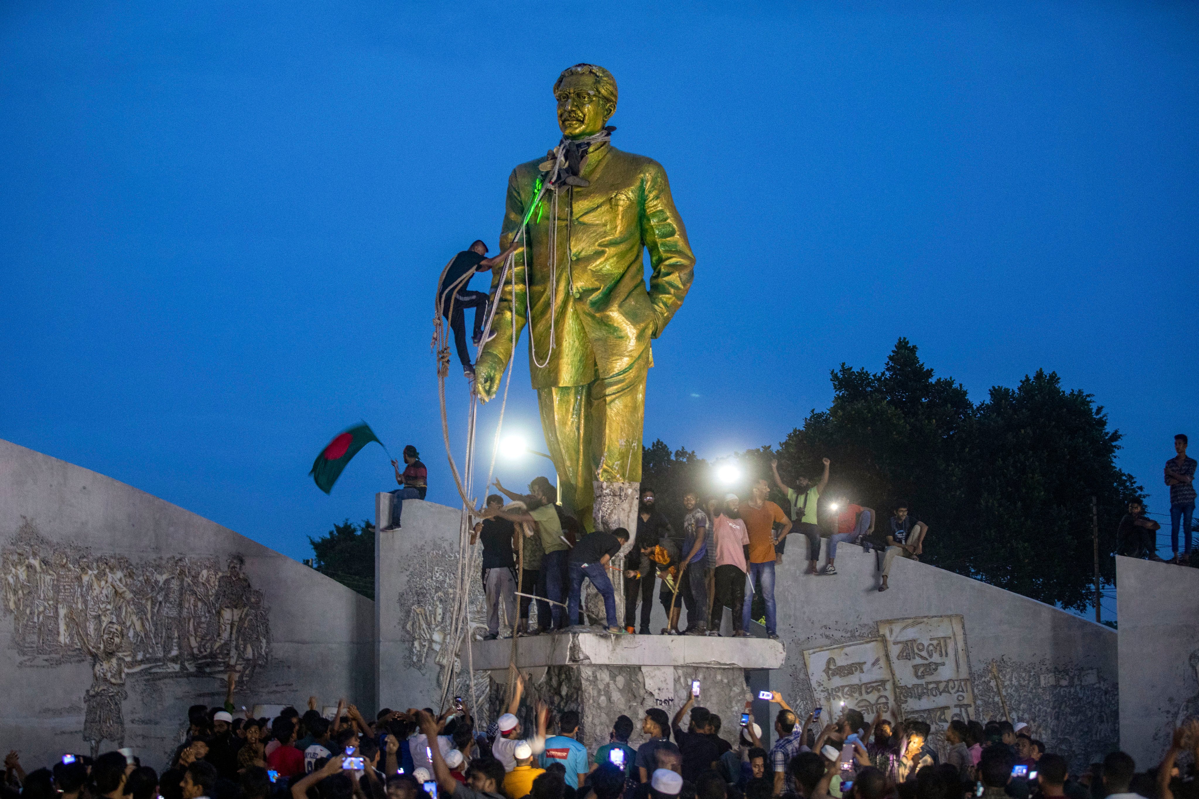 Protesters try to demolish a large statue of Sheikh Mujibur Rahman, father of Bangladesh’s former prime minister Sheikh Hasina, after she resigned in Dhaka, Bangladesh, on August 5. Photo: AP