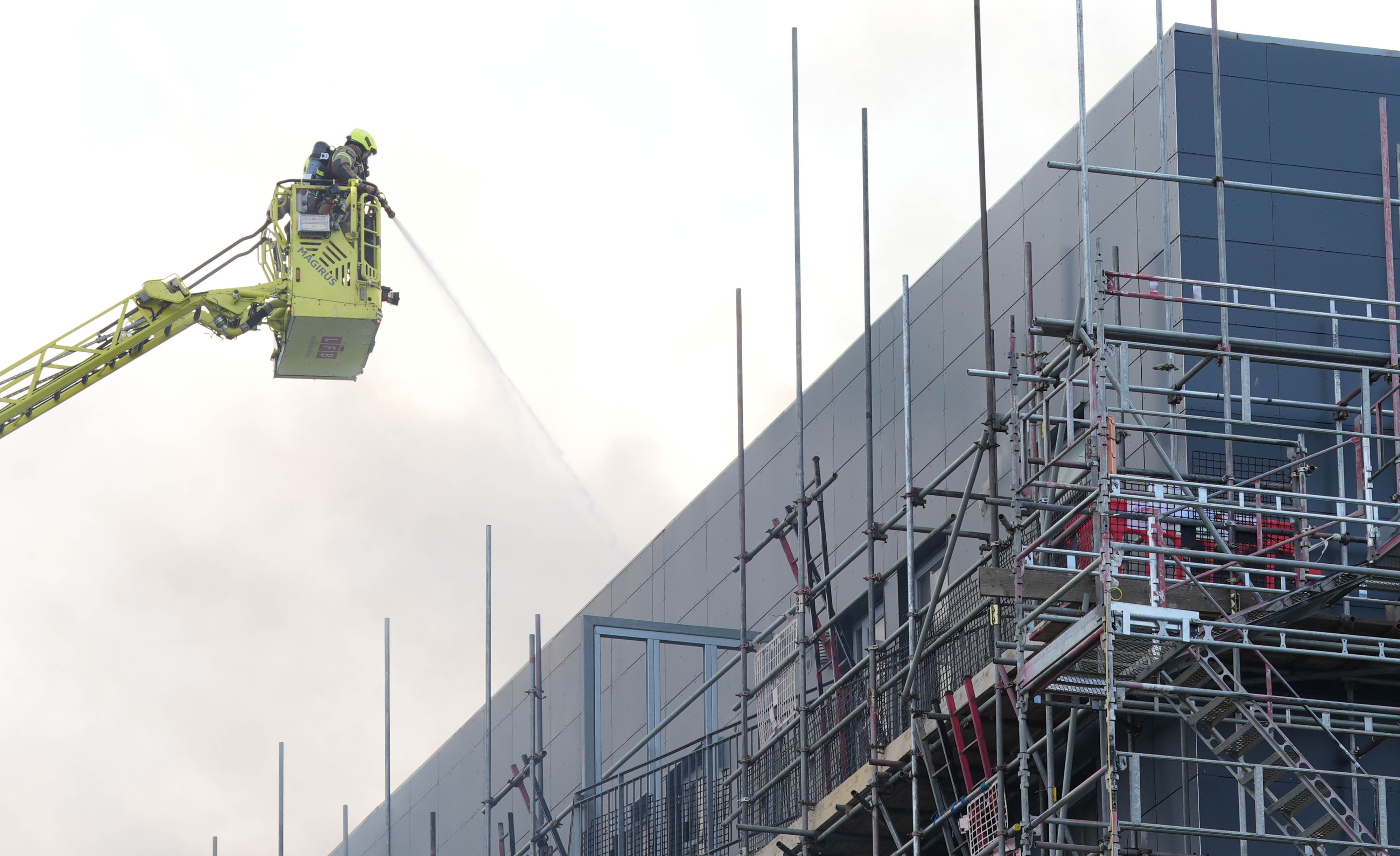 Firefighters at the scene after a blaze at a block of flats on Freshwater Road in Dagenham. More than 100 people were evacuated from the building. Photo: dpa