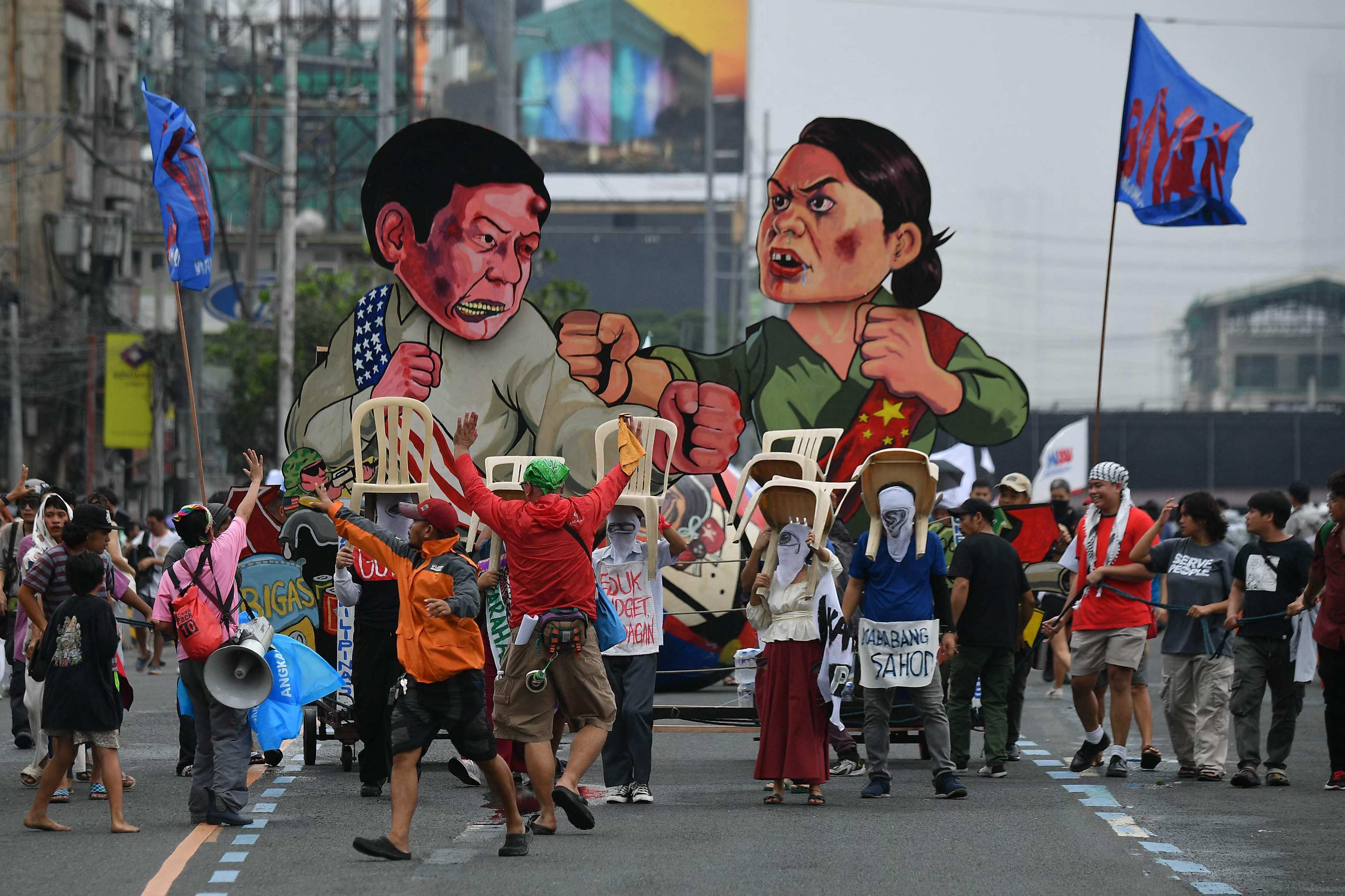 Effigies of Philippine President Ferdinand Marcos Jnr and Vice-President Sara Duterte are seen as protesters march to Congress during a demonstration coinciding with Marcos’ State of the Nation Address in Manila on July 22. Photo: AFP