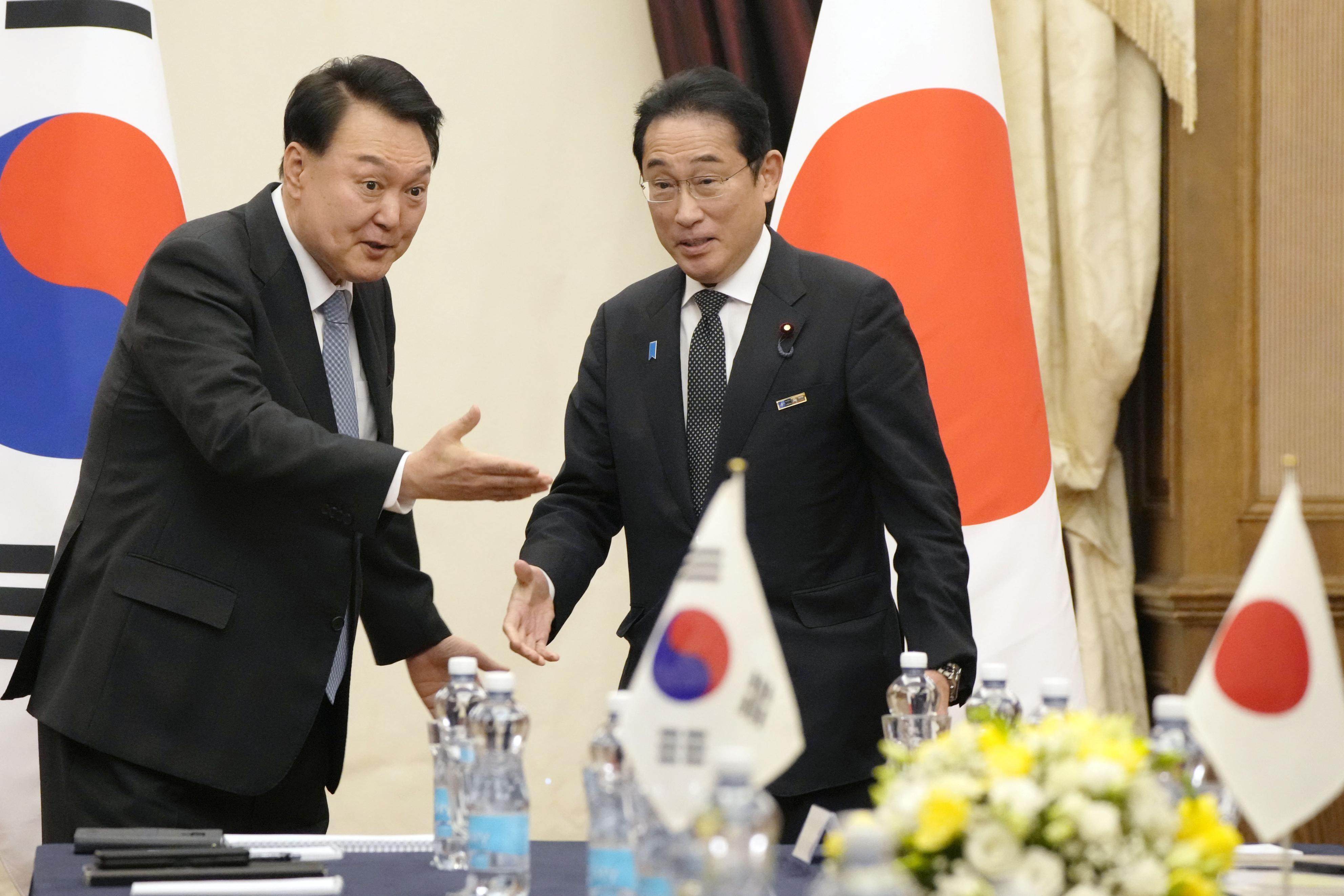 Japanese PM Fumio Kishida and South Korean President Yoon Suk-yeol meet in Lithuania last year. Photo: Kyodo