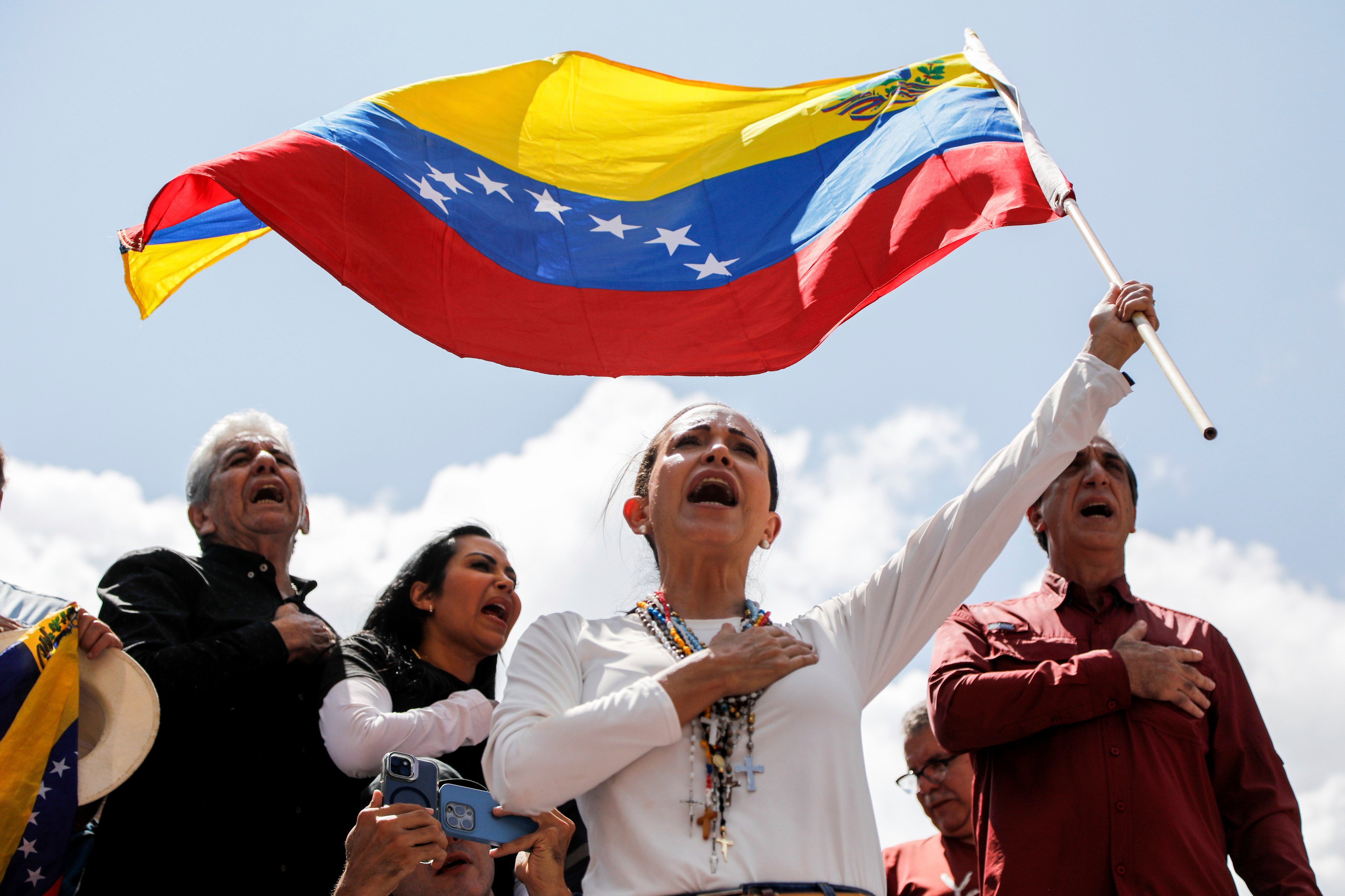 Opposition leader Maria Corina Machado waves a Venezuelan flag during a rally in Caracas, Venezuela, on Saturday. Photo: AP